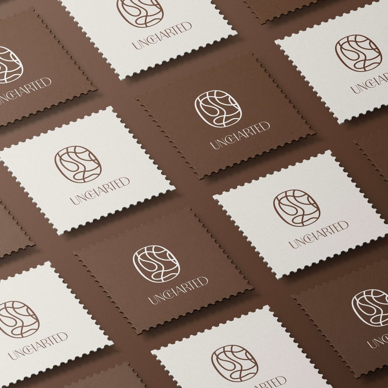 The Uncharted mark repeated as a postage-stamp brand pattern